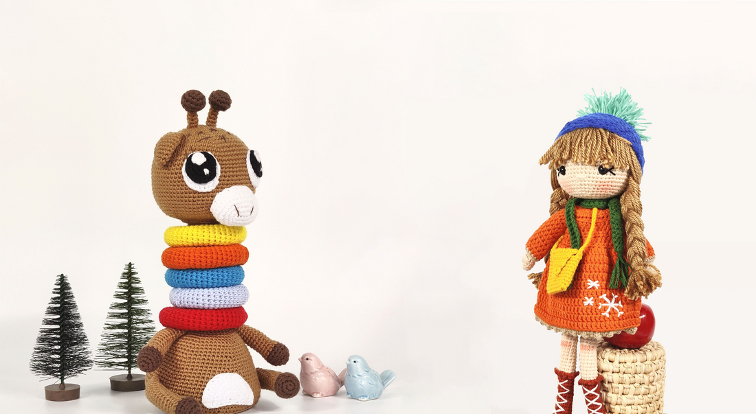 A giraffe and girl amigurumi toys standing